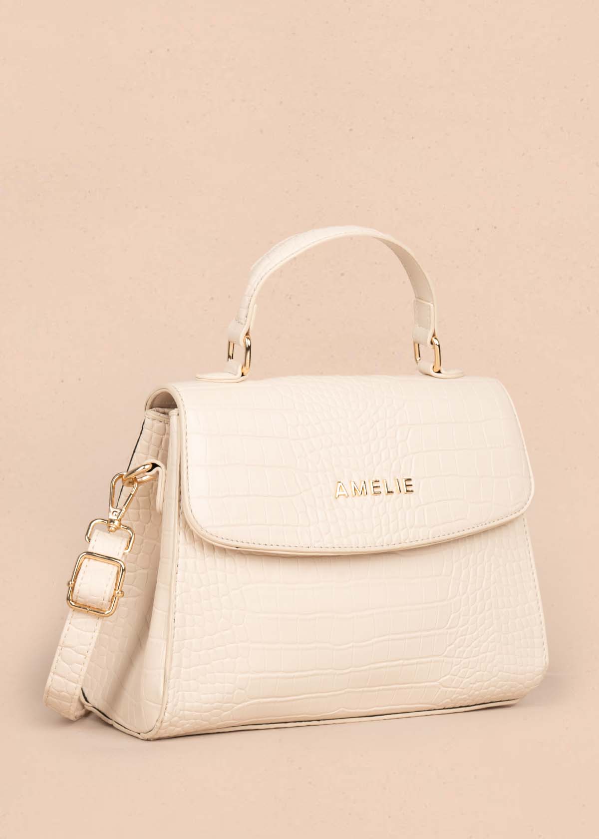 Bolso manos libres color crema con textura croco 105772